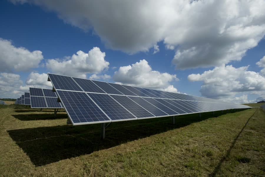 Ground-mounted solar panels under a blue sky